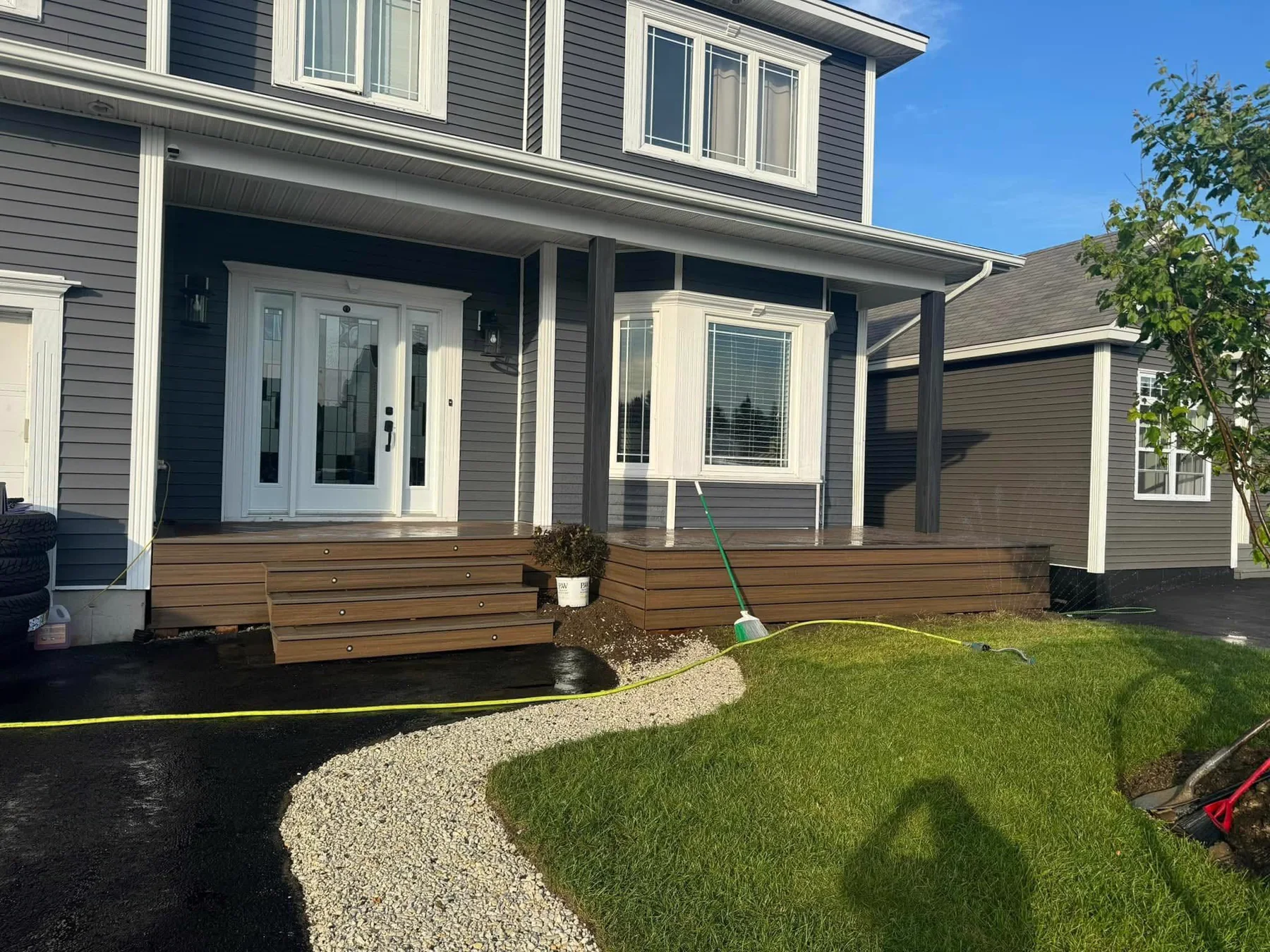 Completed front deck, new lawn and curved gravel landscaping by LBA Contracting
