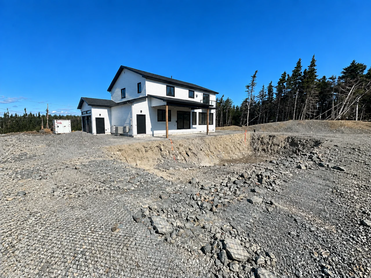 Rocky excavation and prepared backyard site before pool construction